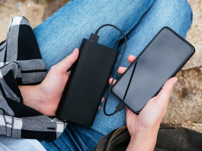 The,Girl,Uses,A,Smartphone,Connected,To,The,Power,Bank.